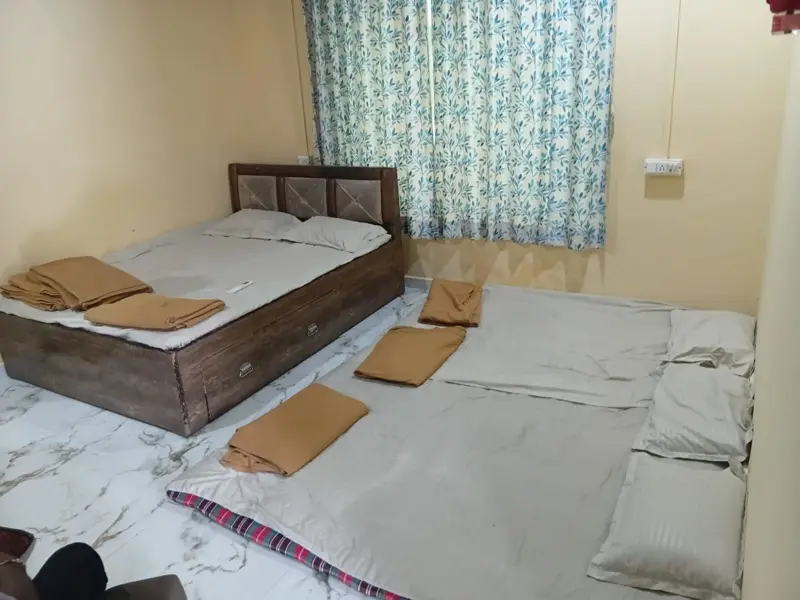 Second private bedroom with bed and floor mattresses