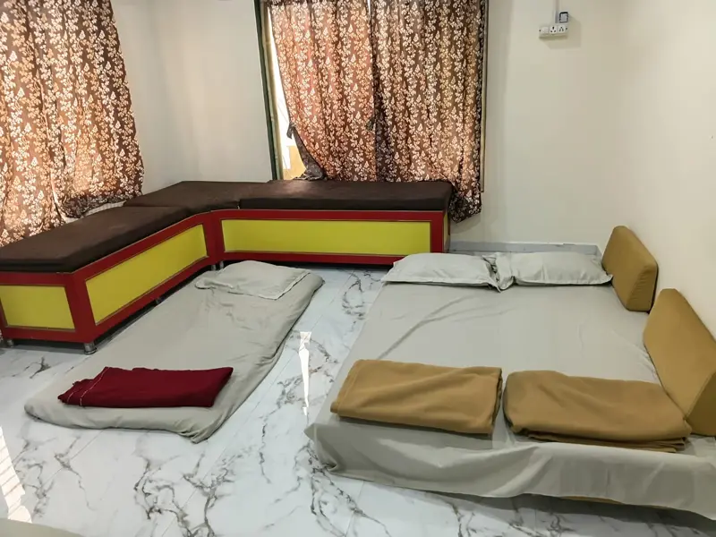 Floor bedding laid out with sheets and blankets for a large group